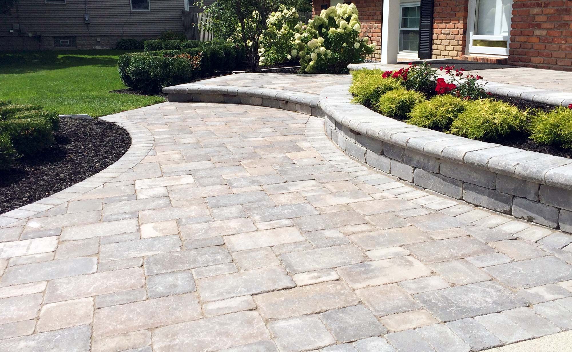 Paver steps with flowering planters.